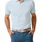 A man in the Johnnie-O Stetson Stripe Performance Mesh Polo—light blue and white stripes—wears blue pants and a woven belt with hands in his pockets, perfect for modern golf style.