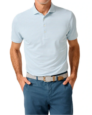 A man in the Johnnie-O Stetson Stripe Performance Mesh Polo—light blue and white stripes—wears blue pants and a woven belt with hands in his pockets, perfect for modern golf style.