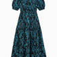 Othella Cotton Dress by Ulla Johnson: A black cotton midi dress with short puff sleeves and a blue floral pattern, featuring a gathered neckline, a fitted waist, and a chic pleated skirt.