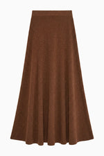 A brown, knee-length Azaria Knit Skirt by Ulla Johnson featuring an A-line silhouette with soft panels and a fitted waistband, crafted from luxurious merino wool and displayed against a white background.