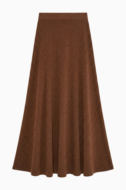 A brown, knee-length Azaria Knit Skirt by Ulla Johnson featuring an A-line silhouette with soft panels and a fitted waistband, crafted from luxurious merino wool and displayed against a white background.