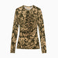 The Asha Jersey Top by Ulla Johnson is a long-sleeve, fitted top featuring a ruched front with gathered detailing and an olive green and beige floral pattern, displayed on a flat white background.