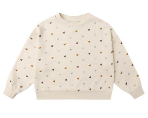 The Girls' Boxy Pullover by Rylee & Cru is a cream French terry sweatshirt featuring a comfy boxy fit and an allover print of small, multicolored hearts.