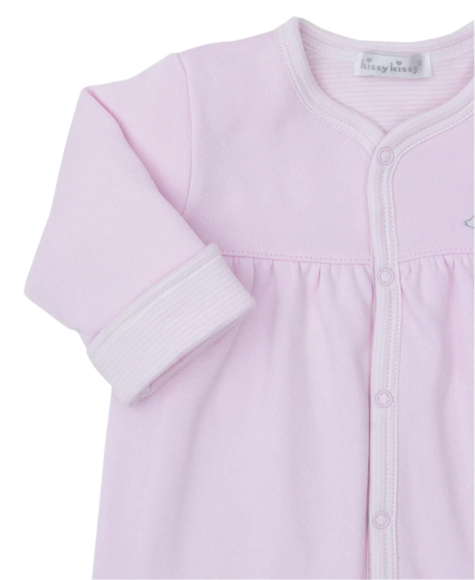 The Baby Forest Fun Reversible Playsuit by Kissy Kissy is a light pink onesie made from soft Pima cotton. It features long sleeves, front button closures, ribbed cuffs, simple stitching, and playful forest animal prints.