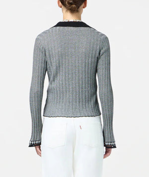 A person wearing the Guest in Residence Fine Stripe Shirt—long-sleeved with ribbed stripes and black trim—and white jeans, shown from the back against a plain background.