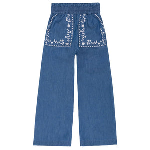 The Minnow Girls' Chambray Embroidered Paperbag Pant features a wide-leg fit, elastic waistband, two front pockets, and white floral embroidery.