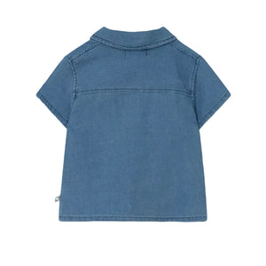 The Cozmo Baby Boys' Forest Chambray Shirt is a short-sleeved, light blue denim shirt with a collar and visible seam details, shown from the back.