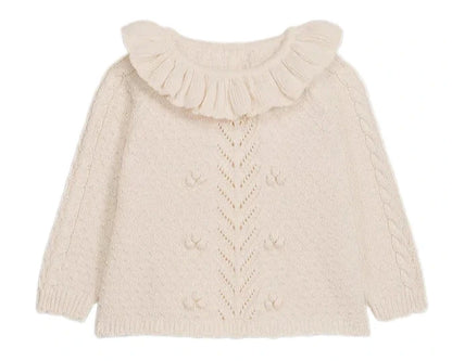 The Louise Misha Baby Girls' Evina Sweater is a cream knit with a ruffled Pierrot collar, decorative front stitches, and cable knit sleeve details.