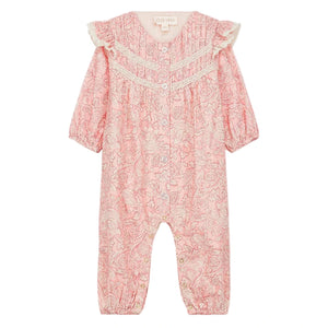 The Louise Misha Baby Girls' Lilany Jumpsuit features a pink base with a white floral pattern, long sleeves, lace shoulder details, ruffled armholes, button-down front, and elastic cuffs at wrists and ankles.