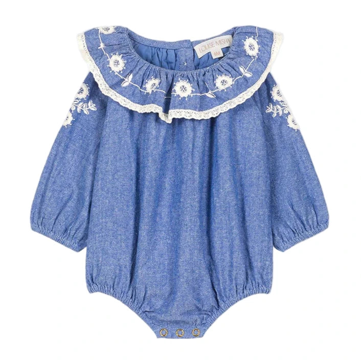The Louise Misha Baby Girls' Ilani Romper features long sleeves, white floral embroidery, lace-trimmed ruffled collar, elastic cuffs, and convenient snap buttons at the bottom.