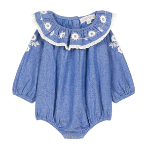 The Louise Misha Baby Girls' Ilani Romper features long sleeves, white floral embroidery, lace-trimmed ruffled collar, elastic cuffs, and convenient snap buttons at the bottom.