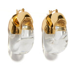 The Lizzie Fortunato Organic Gold Hoops are chunky resin earrings with gold-toned tops and translucent clear lower sections.