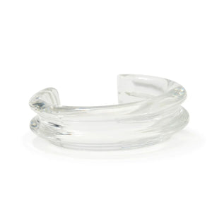 Lizzie Fortunato's Onda Cuff is a clear, thick acrylic bracelet featuring a smooth, sculptural open-ended design.