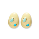 The Lizzie Fortunato Mini Arp Earrings from Lizzie Fortunato feature a set of ivory-colored mini teardrop earrings, each adorned with two turquoise stones—one small and one larger—set against a white background.