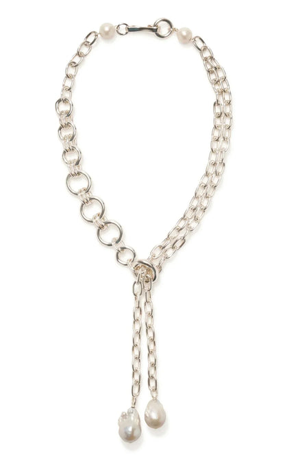 The Lizzie Fortunato Edith Lariat from Lizzie Fortunato is an exquisite piece of silver jewelry. This asymmetrical silver chain necklace showcases oversized freshwater baroque pearls as pendants, complemented by additional pearl accents cascading on one side.