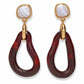 The Galina Earrings by Lizzie Fortunato feature gold and marbled white studs with large, irregular maroon resin hoops that dangle below, evoking the look of glass teardrop hoops.