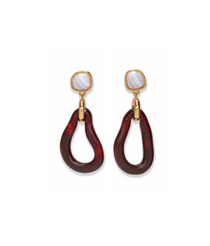 The Galina Earrings by Lizzie Fortunato feature gold and marbled white studs with large, irregular maroon resin hoops that dangle below, evoking the look of glass teardrop hoops.