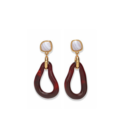 The Galina Earrings by Lizzie Fortunato feature gold and marbled white studs with large, irregular maroon resin hoops that dangle below, evoking the look of glass teardrop hoops.