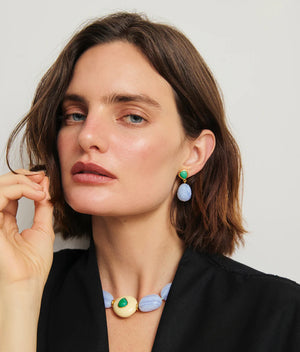 Woman with short brown hair wears a black top, blue and cream beaded necklace, and Lizzie Fortunato Andalusia Earrings featuring blue chalcedony and green chrysoprase as she looks at the camera.
