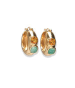 The Piet Hoop Earrings by Lizzie Fortunato are gold-plated hoops, each adorned with a yellow hessonite garnet and a green amazonite cabochon.