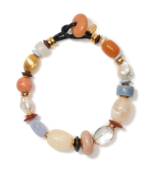 The Monument Collar by Lizzie Fortunato is a beaded bracelet with mixed stones, freshwater pearls, and gold accents on a black cord, finished with a circular stone clasp.