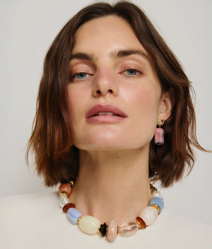 A woman with short brown hair wears the Lizzie Fortunato Monument Collar and matching rectangular earrings, looking directly at the camera.