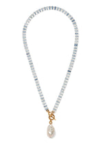 The Pearl Isle Necklace by Lizzie Fortunato features alternating light blue and white beads, a gold-plated toggle clasp, and a unique baroque freshwater pearl pendant.