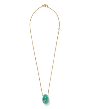 The Constance Necklace by Lizzie Fortunato features a gold-plated brass chain and a turquoise, egg-shaped amazonite pendant with a central decorative accent.