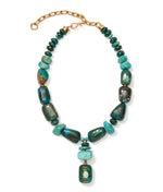 The Andamento Necklace by Lizzie Fortunato features chunky turquoise beads, gold chain links, and a rectangular turquoise pendant with a round accent.