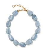The Sea and Sky Collar by Lizzie Fortunato is a chunky beaded statement necklace featuring irregularly shaped blue opal stones, accented with small green amazonite beads and finished with a gold chain clasp.