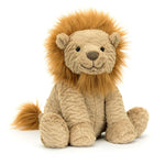 A Jellycat Fuddlewuddle Lion, Large with a tan body and an amber mane of fluffy, light brown fur sits facing forward. The lion features a smiling face and a tufted tail.