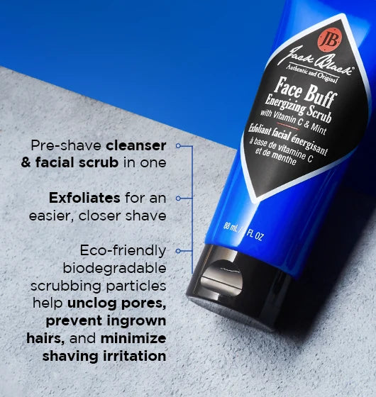 A blue tube of Jack Black Face Buff Energizing Scrub rests on a blue surface, with text emphasizing its exfoliating and pre-shave cleanser benefits, eco-friendly scrubbing particles, and its ability to help unclog pores while reducing shaving irritation.