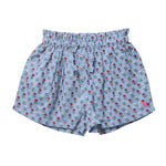 Girls’ Theodore Short by Pink Chicken in light blue, styled with an elastic waist and adorned with a delightful blockprint pattern of small red and white flowers with green leaves.