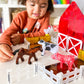 Kid playing with arm Animals 25-Piece set, part of the MAGNA-TILES.