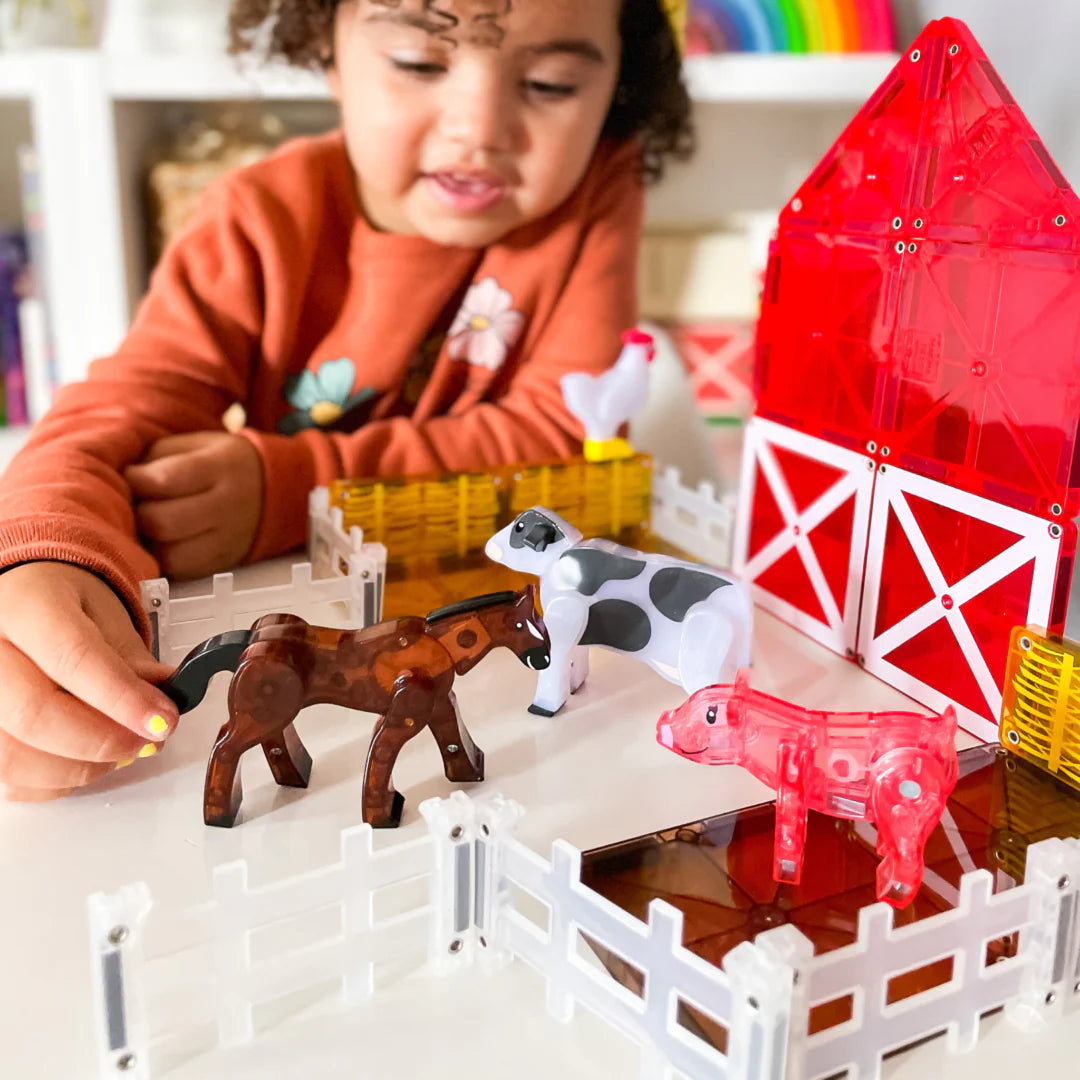 Kid playing with arm Animals 25-Piece set, part of the MAGNA-TILES.