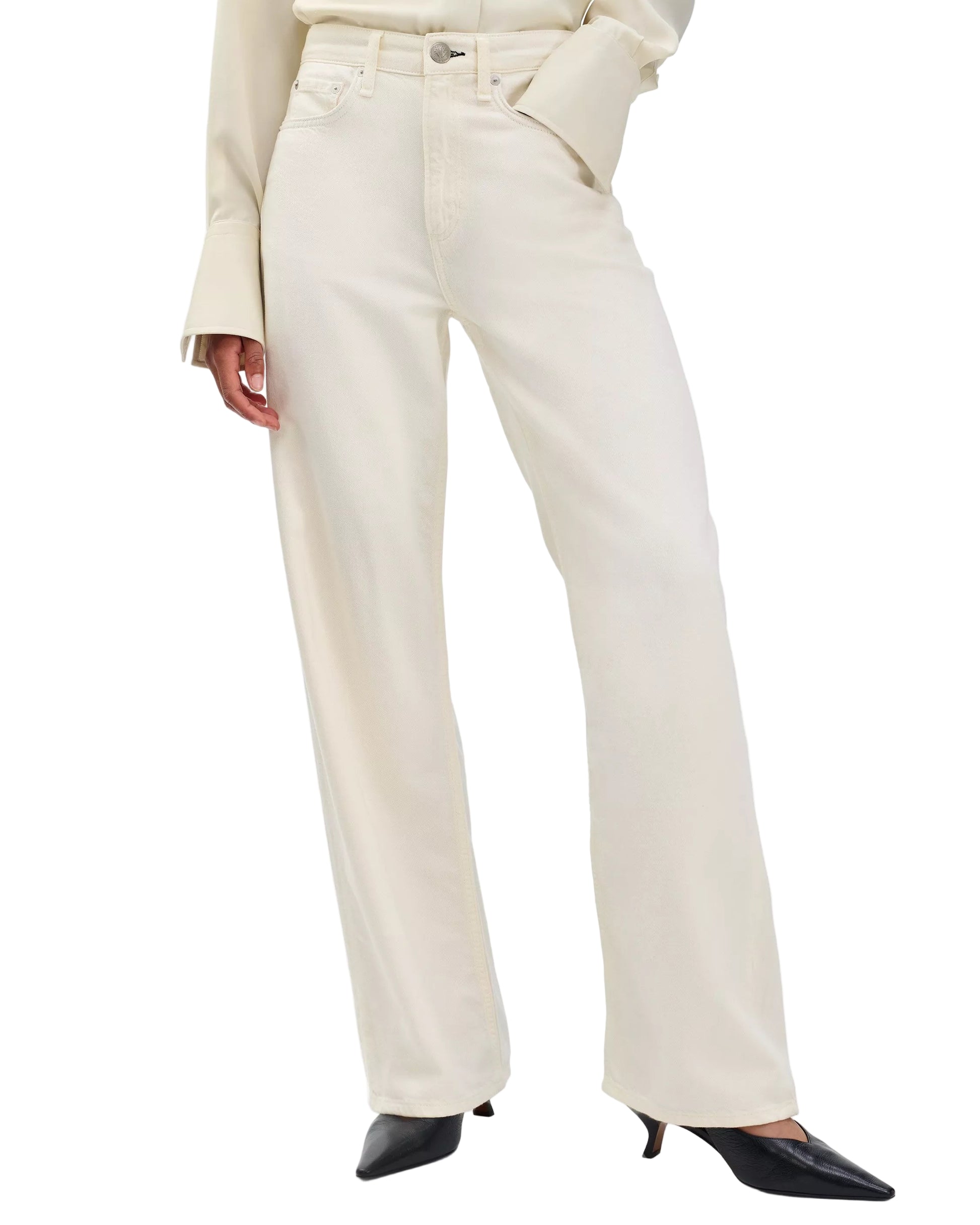 A person wearing Rag & Bone's Featherweight Logan off-white wide leg jeans with a matching long-sleeve top and black pointed-toe heels.