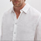 A man models the Rag & Bone Finch Linen Shirt—a relaxed fit, long sleeve linen piece—standing against a plain, light background with his face partially out of frame.