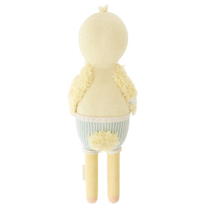 Finley the Duckling by Cuddle + Kind is a 20" knitted plush toy with a fluffy yellow vest, small tail, and long legs—perfect as a charming birthday gift.