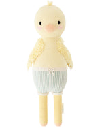 Finley the Duckling by Cuddle + Kind is a 20" knitted yellow plush with fluffy wings, pink cheeks, and blue striped shorts—an adorable choice for a birthday gift.