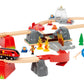 The BRIO World Fire Rescue Smart Tech Set by Brio is a vibrant toy set that includes tracks, bridges, tunnels, and a red and black fire rescue train. It comes with small figurines, trees, and a convenient blue bag. The Smart Tech Sound system adds interactive sounds for an immersive play experience.