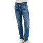 A person wearing Rag & Bone Fit 2 Authentic Stretch Denim jeans in medium indigo, paired with a white shirt and off-white sneakers, stands facing forward with arms folded.