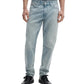 A person wearing Rag & Bone Fit 3 Authentic Stretch light blue tapered leg jeans and black shoes, standing with arms relaxed at their sides, shown from shoulders to feet.