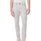 A person wearing Rag & Bone Fit 3 Aero Stretch Athletic Jeans in light gray, a white t-shirt, and beige sneakers stands against a plain white background.