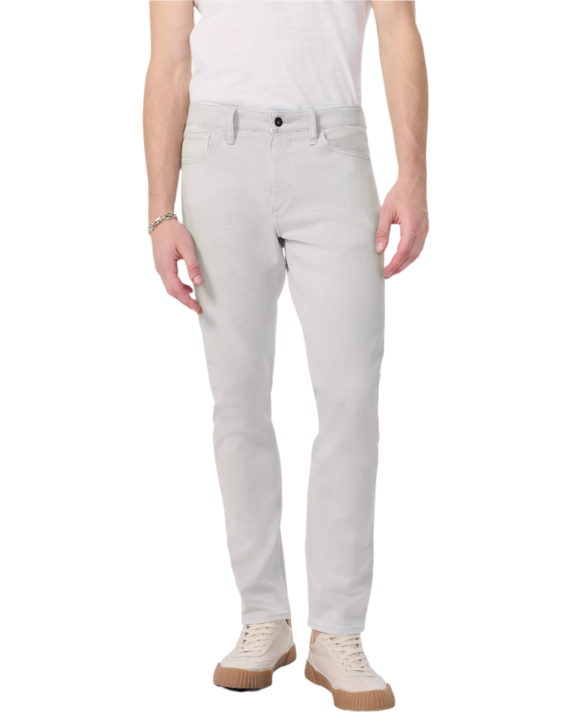 A person wearing Rag & Bone Fit 3 Aero Stretch Athletic Jeans in light gray, a white t-shirt, and beige sneakers stands against a plain white background.