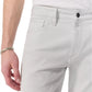 A person wearing Rag & Bone Fit 3 Aero Stretch Athletic Jeans in light gray and a white shirt, with a silver bracelet on their left wrist.