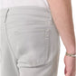 Wearing Rag & Bone Fit 3 Aero Stretch Athletic Jeans in light gray with an athletic fit, paired with a white shirt; the back pocket and right arm with a silver bracelet are visible.