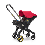 The Doona Car Seat and Stroller by Doona is a vibrant red and black stroller with yellow accents that seamlessly integrates a detachable car seat into its design, providing a convenient four-wheeled travel system.