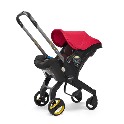 The Doona Car Seat and Stroller by Doona is a vibrant red and black stroller with yellow accents that seamlessly integrates a detachable car seat into its design, providing a convenient four-wheeled travel system.