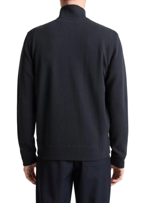 A person is shown from the back against a white background, wearing vince's Flat Back Piqué Full Zip jacket and matching pants with a minimal silhouette.