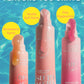 Three tubes of Supergoop Glow Gloss Lip Balm SPF 40—Strawberry Spritz, Vanilla Soft Serve, and Pink Peppermint—stand upright against a blue water background for ultra-hydrated, non-sticky lips.